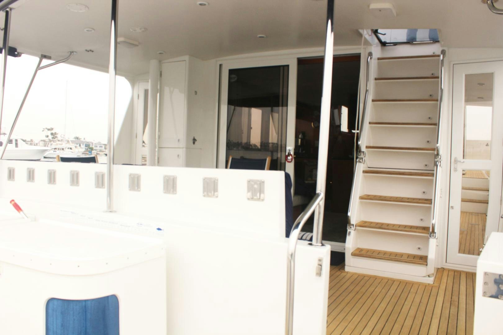 a room with white cabinets and a ladder aboard LADY CYNTHIA Yacht for Sale