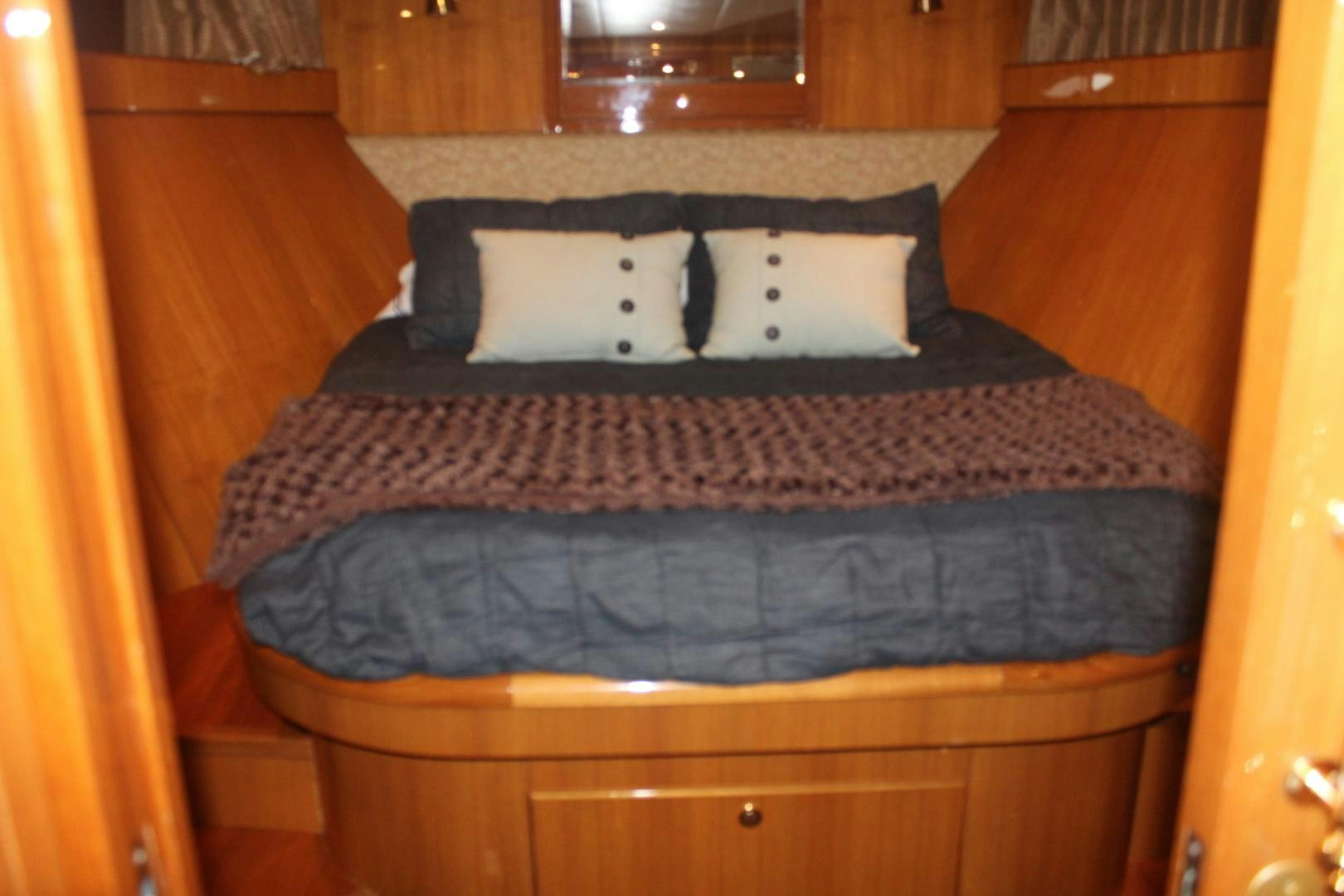 a bed with a black and white blanket on it aboard LADY CYNTHIA Yacht for Sale