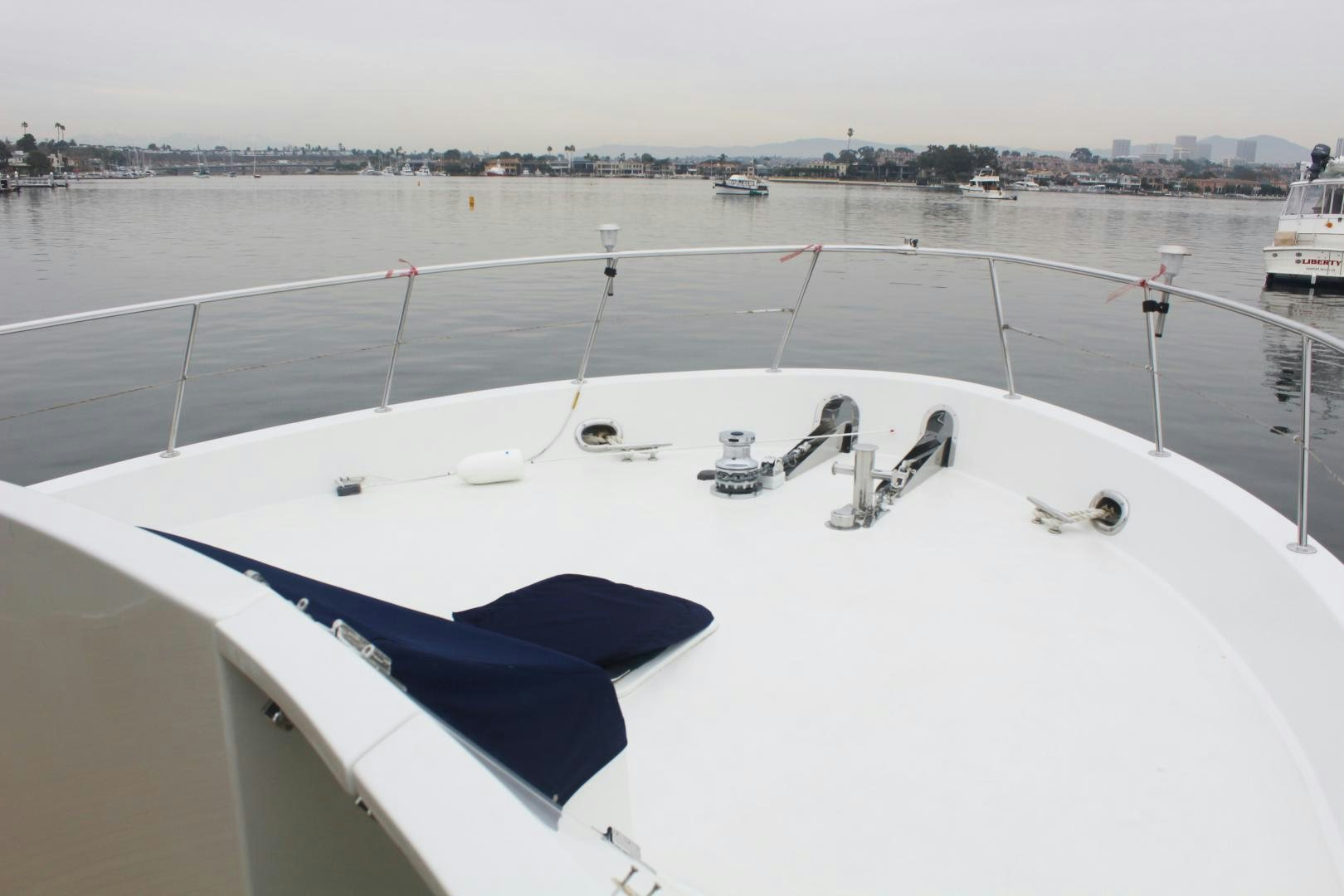 a large white boat with a blue cover on the front aboard LADY CYNTHIA Yacht for Sale