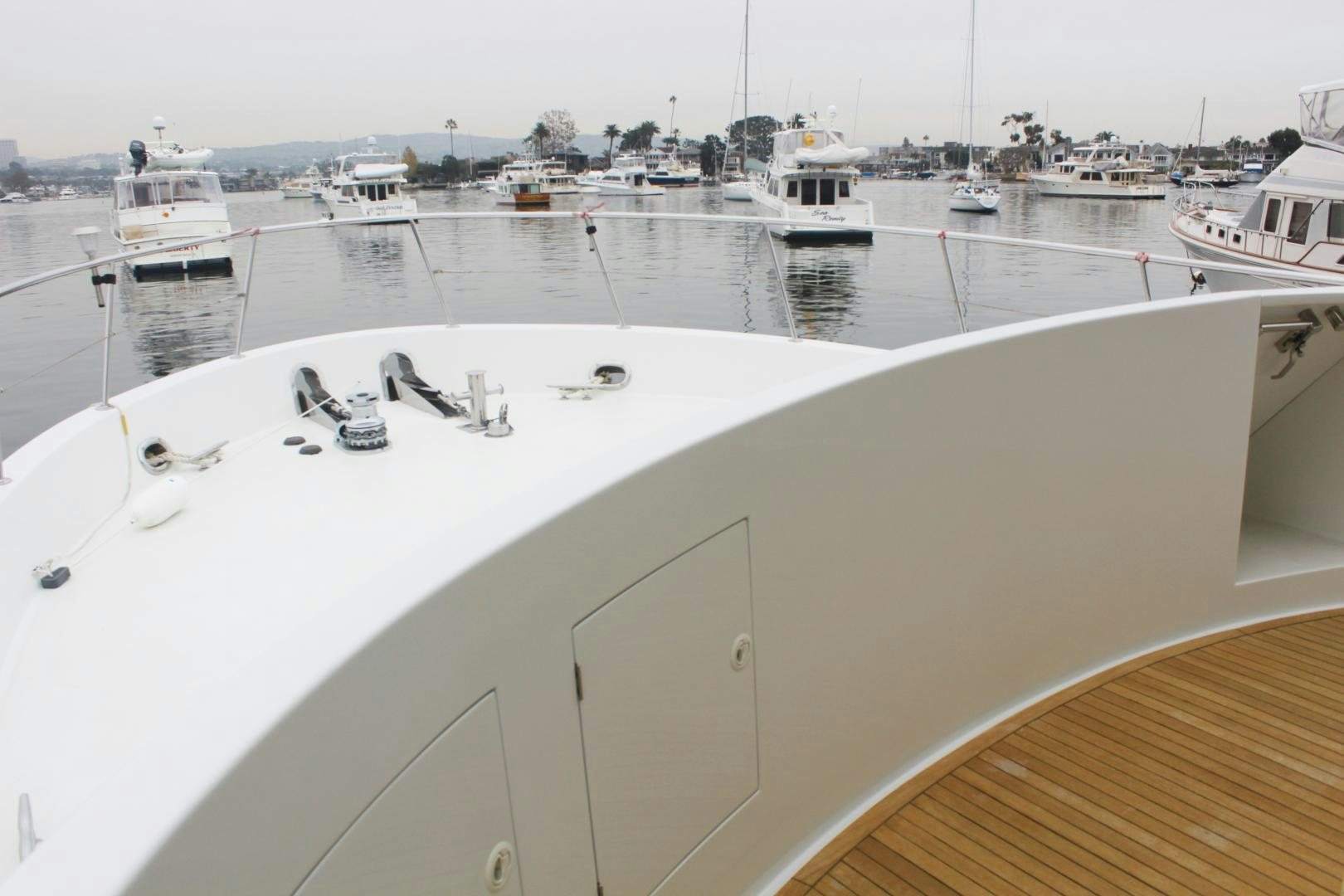a large white boat in a harbor aboard LADY CYNTHIA Yacht for Sale