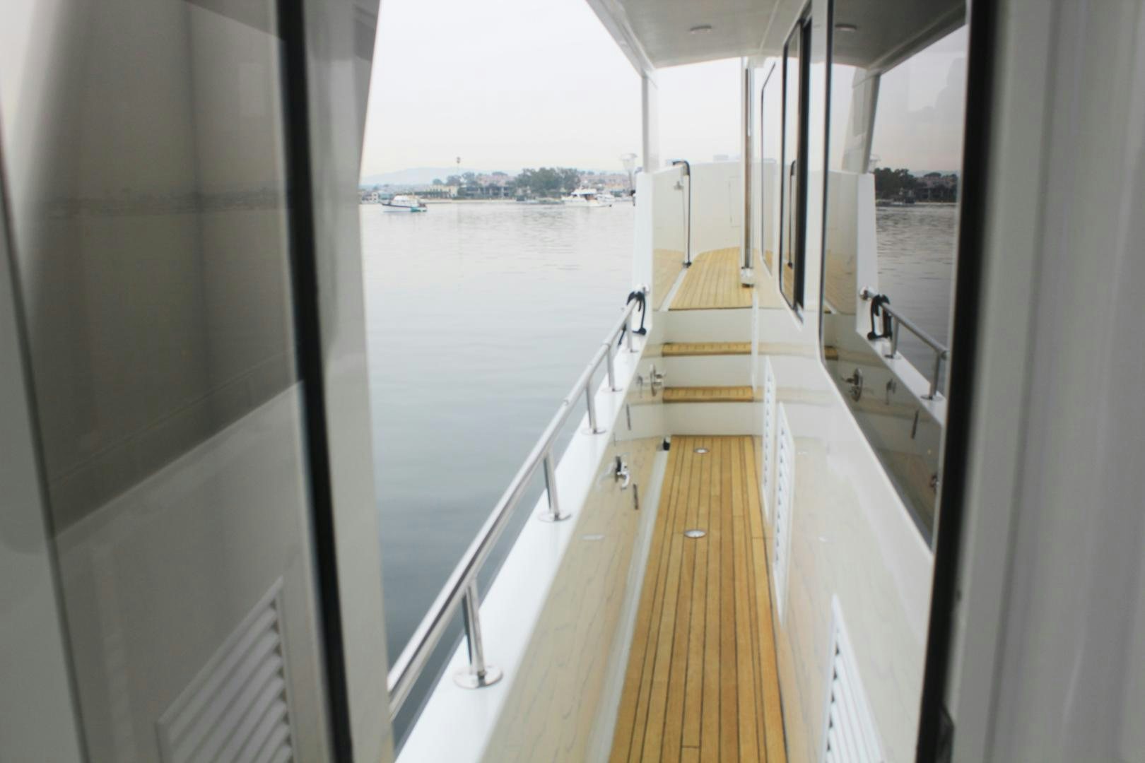 a long hallway with a railing aboard LADY CYNTHIA Yacht for Sale
