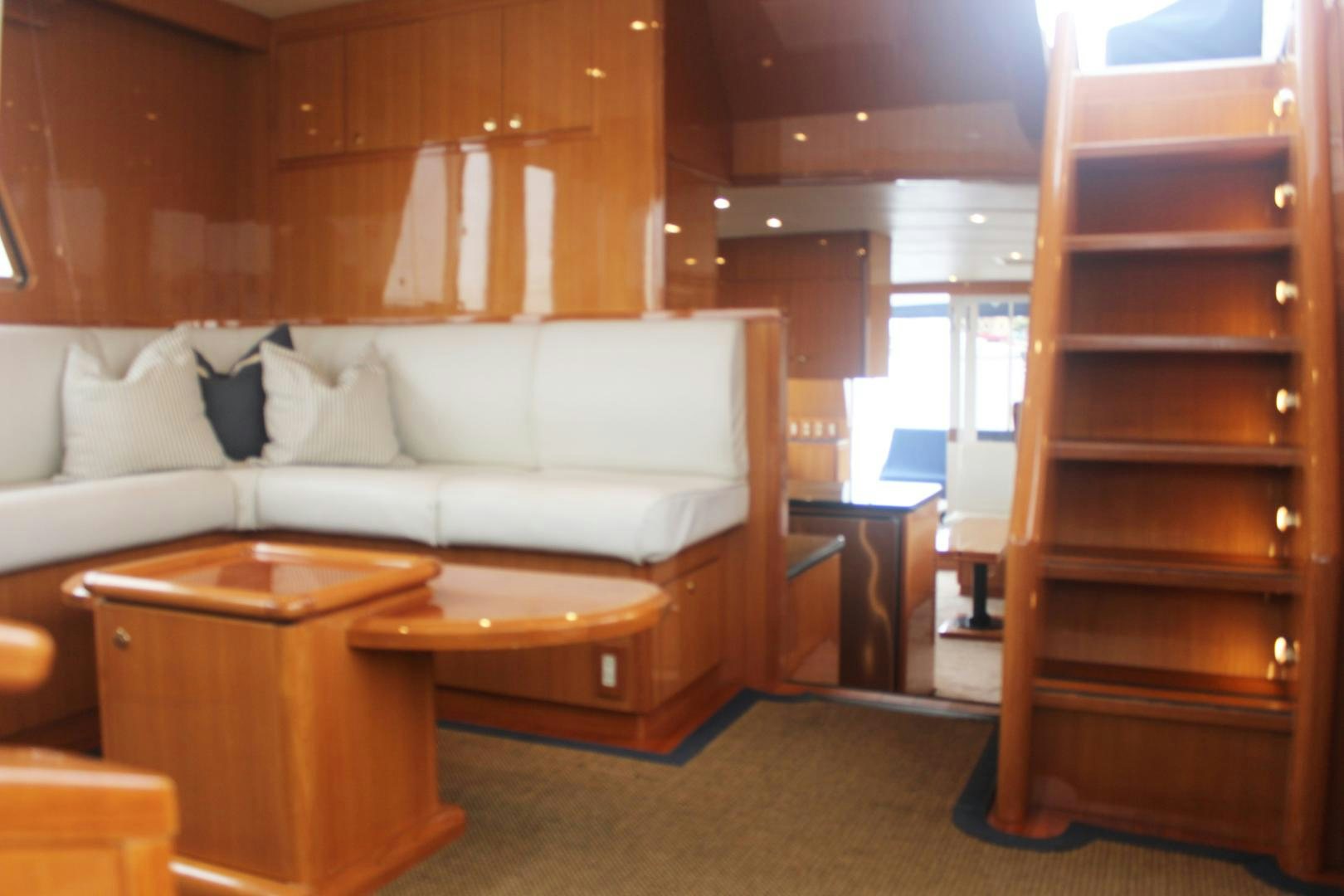 a living room with a couch and a table aboard LADY CYNTHIA Yacht for Sale