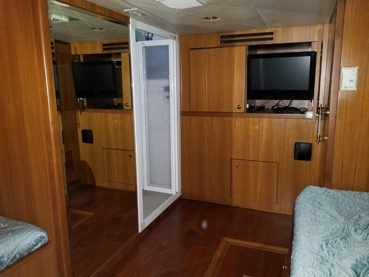 a room with a tv and a couch aboard LADY CYNTHIA Yacht for Sale