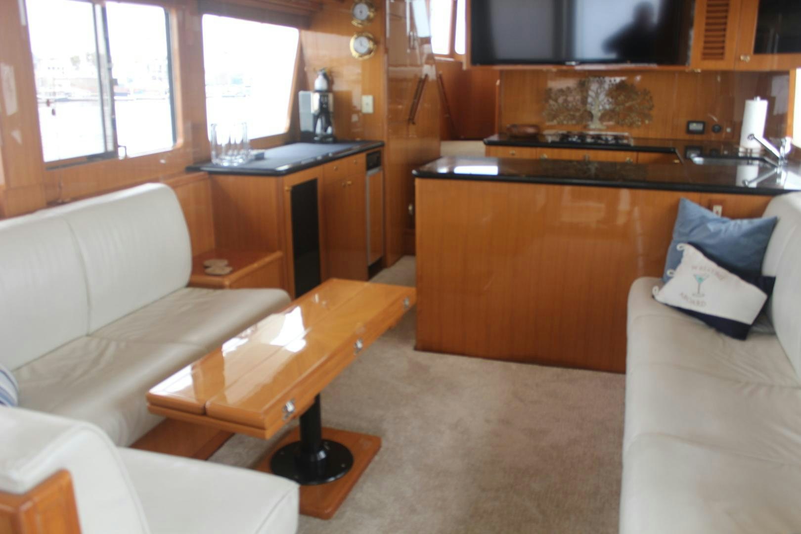 a living room with a couch and a table aboard LADY CYNTHIA Yacht for Sale
