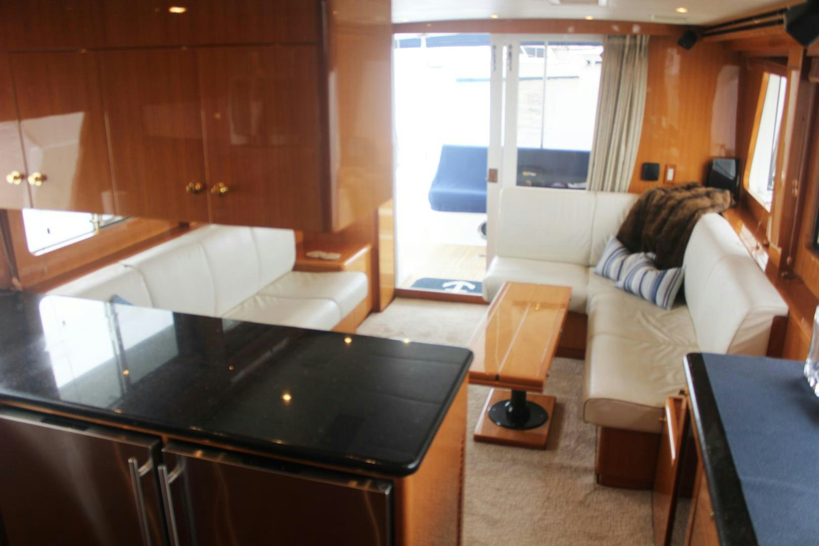 a person sitting on a couch in a living room aboard LADY CYNTHIA Yacht for Sale