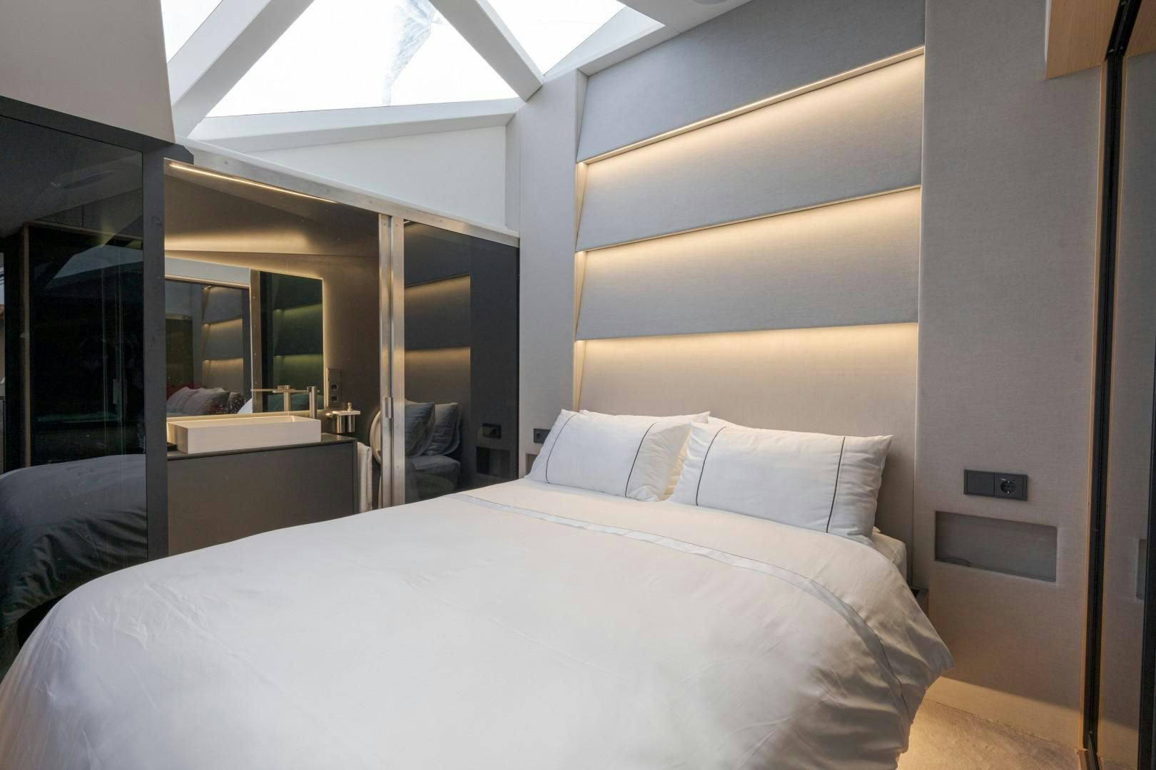 a bed with white sheets aboard X1 Yacht for Sale
