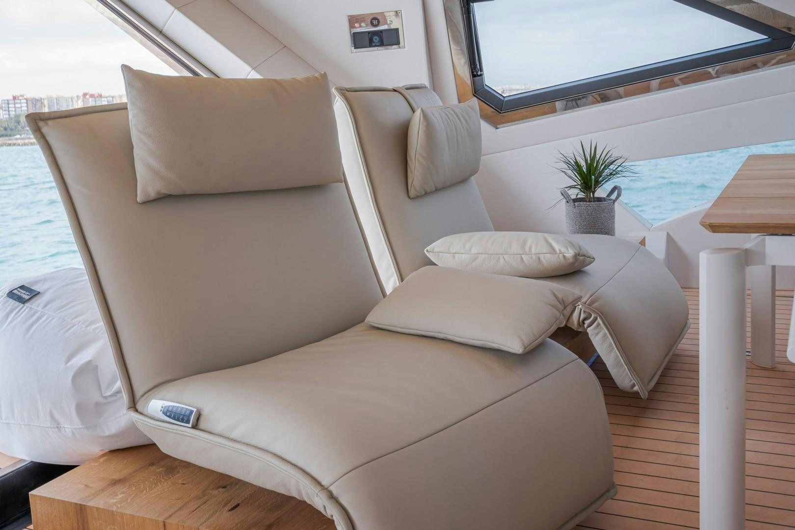 a couch with pillows on it aboard X1 Yacht for Sale