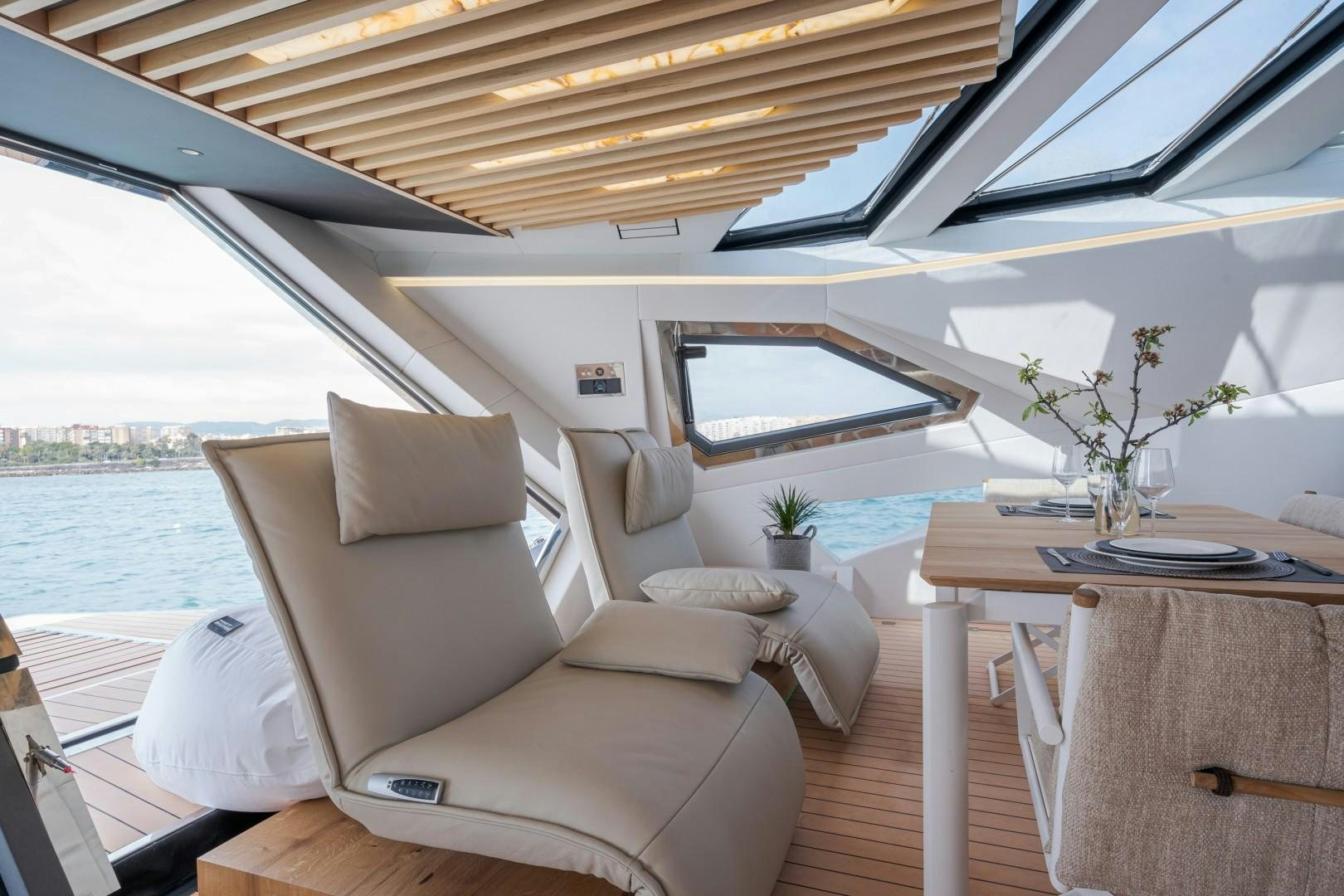 a room with a table and chairs aboard X1 Yacht for Sale