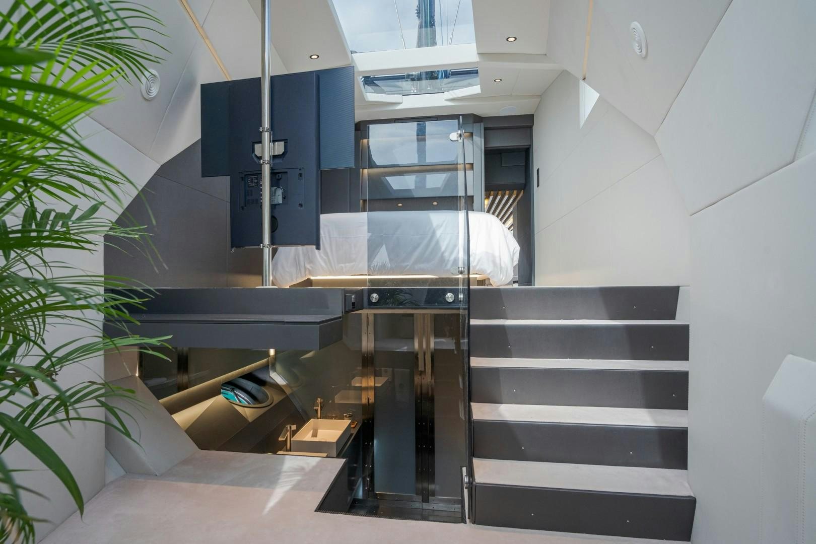 a room with a bed and a desk aboard X1 Yacht for Sale