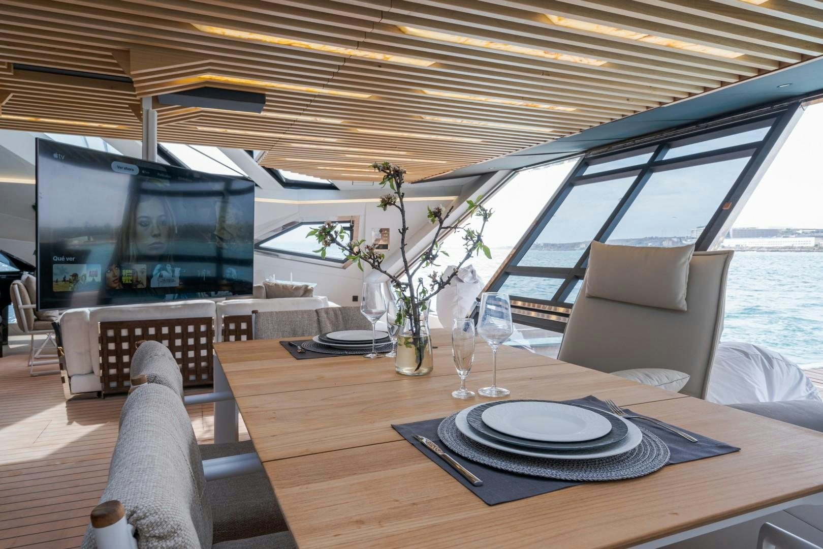 a table with plates and a television aboard X1 Yacht for Sale