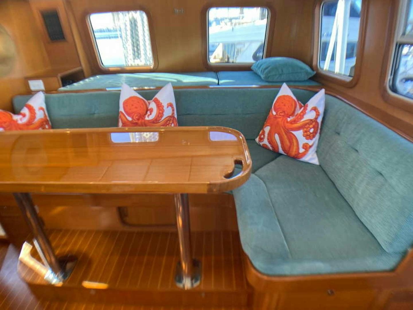 a couch with a table on it aboard RHINO 1 Yacht for Sale