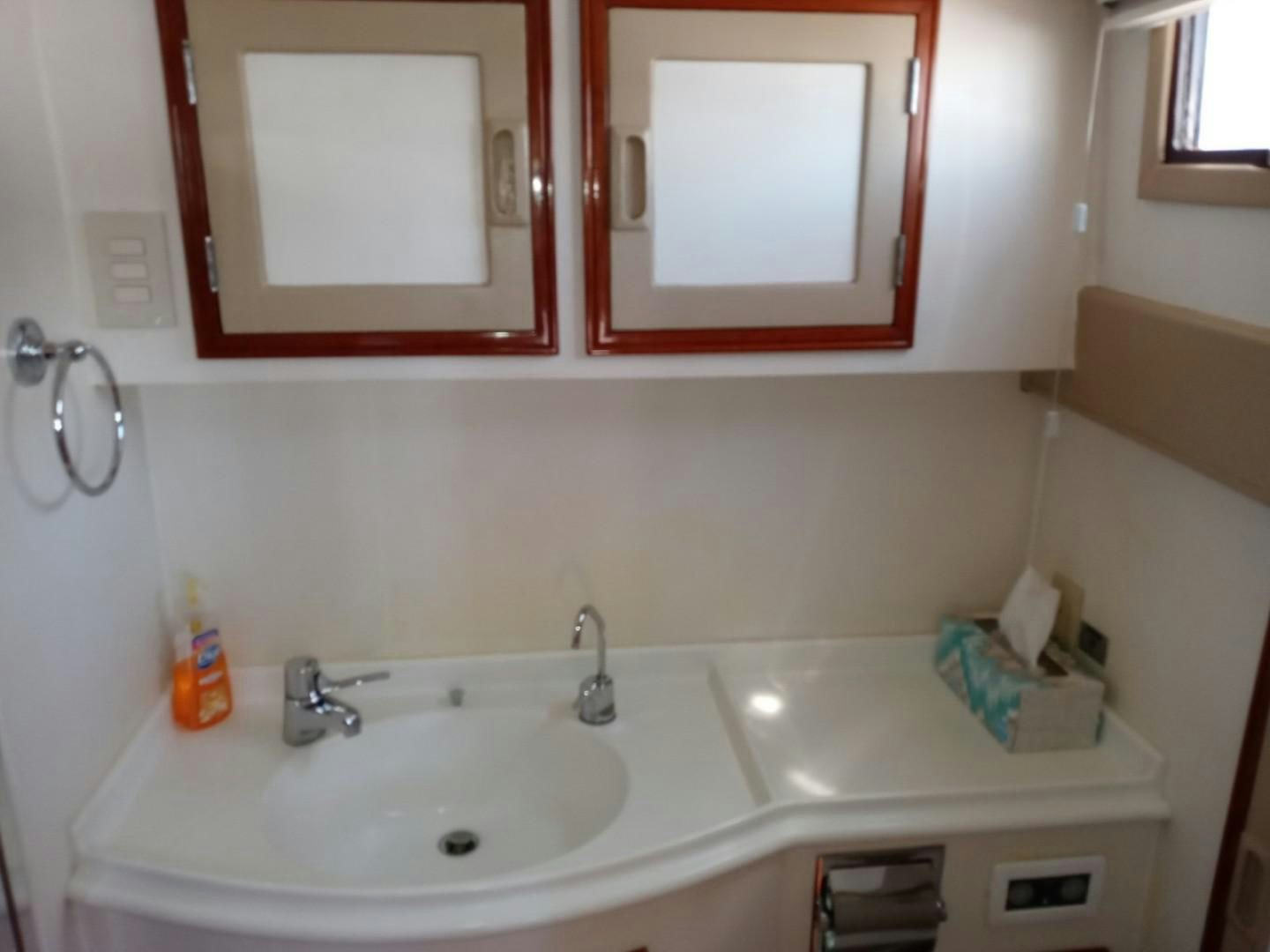 a bathroom with a mirror and a sink aboard DESTINATION Yacht for Sale
