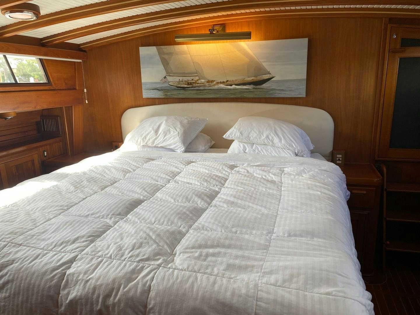 a bed with white sheets aboard DESTINATION Yacht for Sale