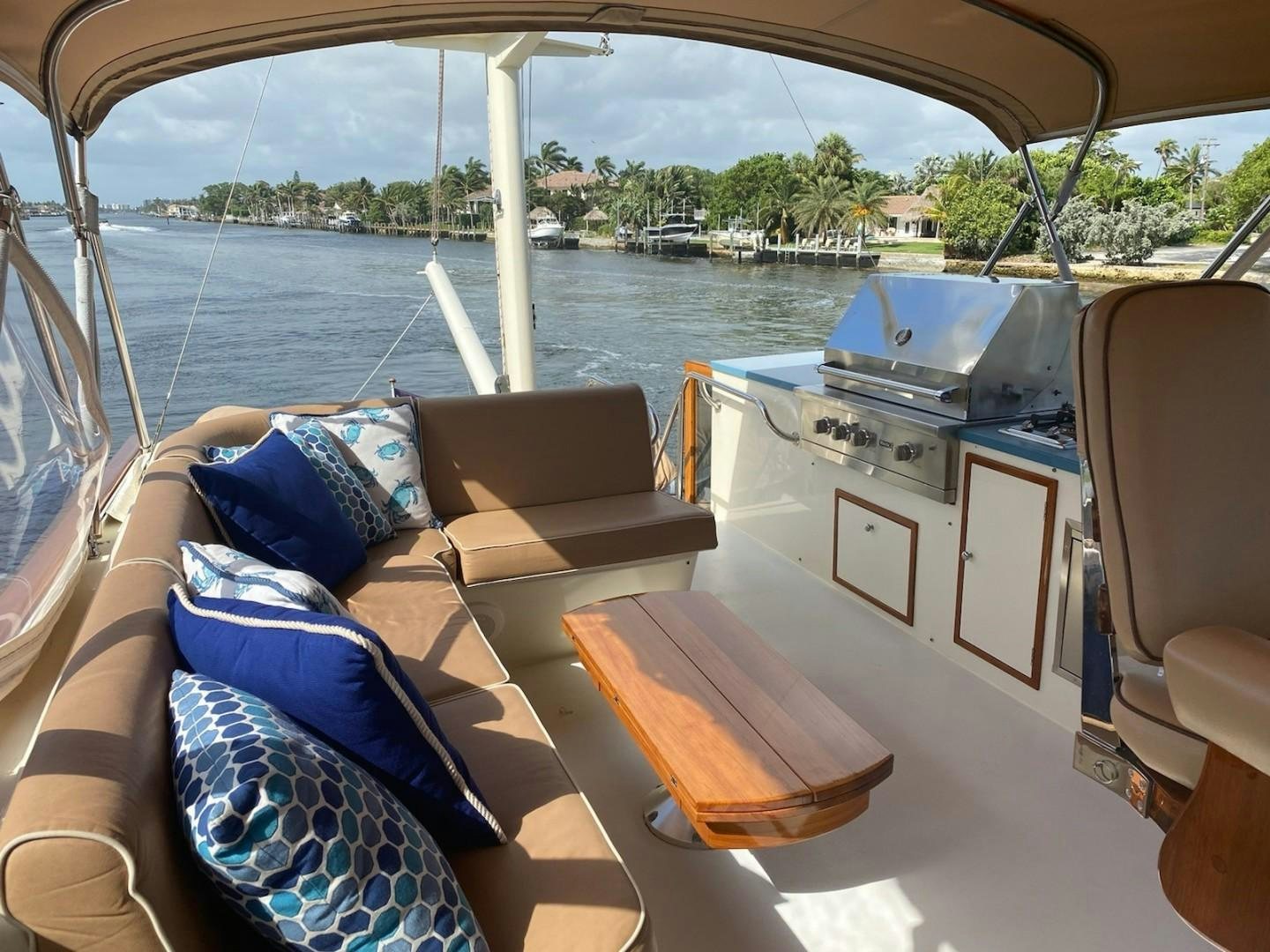 a boat with a seat and a table with chairs on it aboard DESTINATION Yacht for Sale