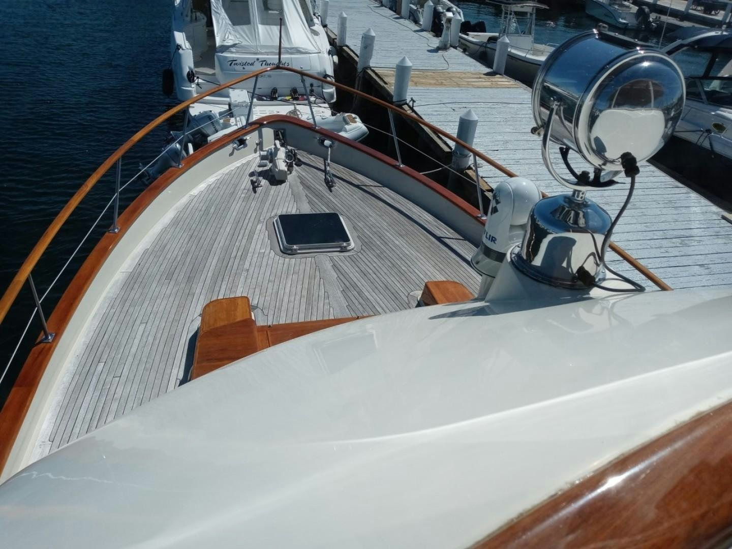 a large white boat with a black center aboard DESTINATION Yacht for Sale