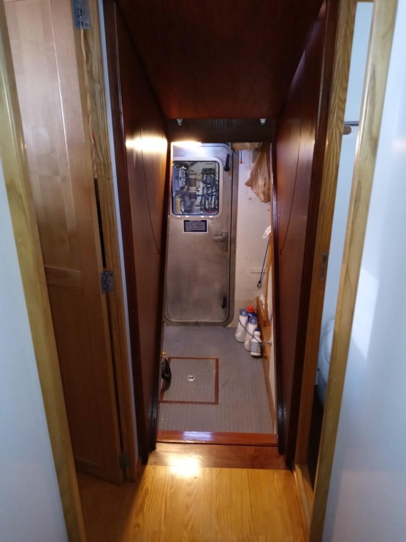 a hallway with a door aboard DESTINATION Yacht for Sale