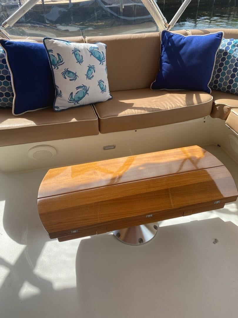 a wooden bench with pillows aboard DESTINATION Yacht for Sale