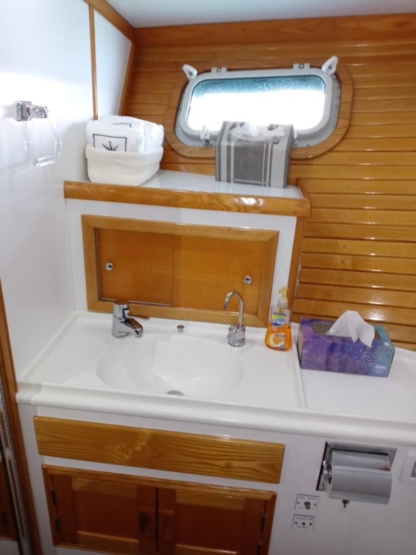 a sink with a mirror above it aboard DESTINATION Yacht for Sale