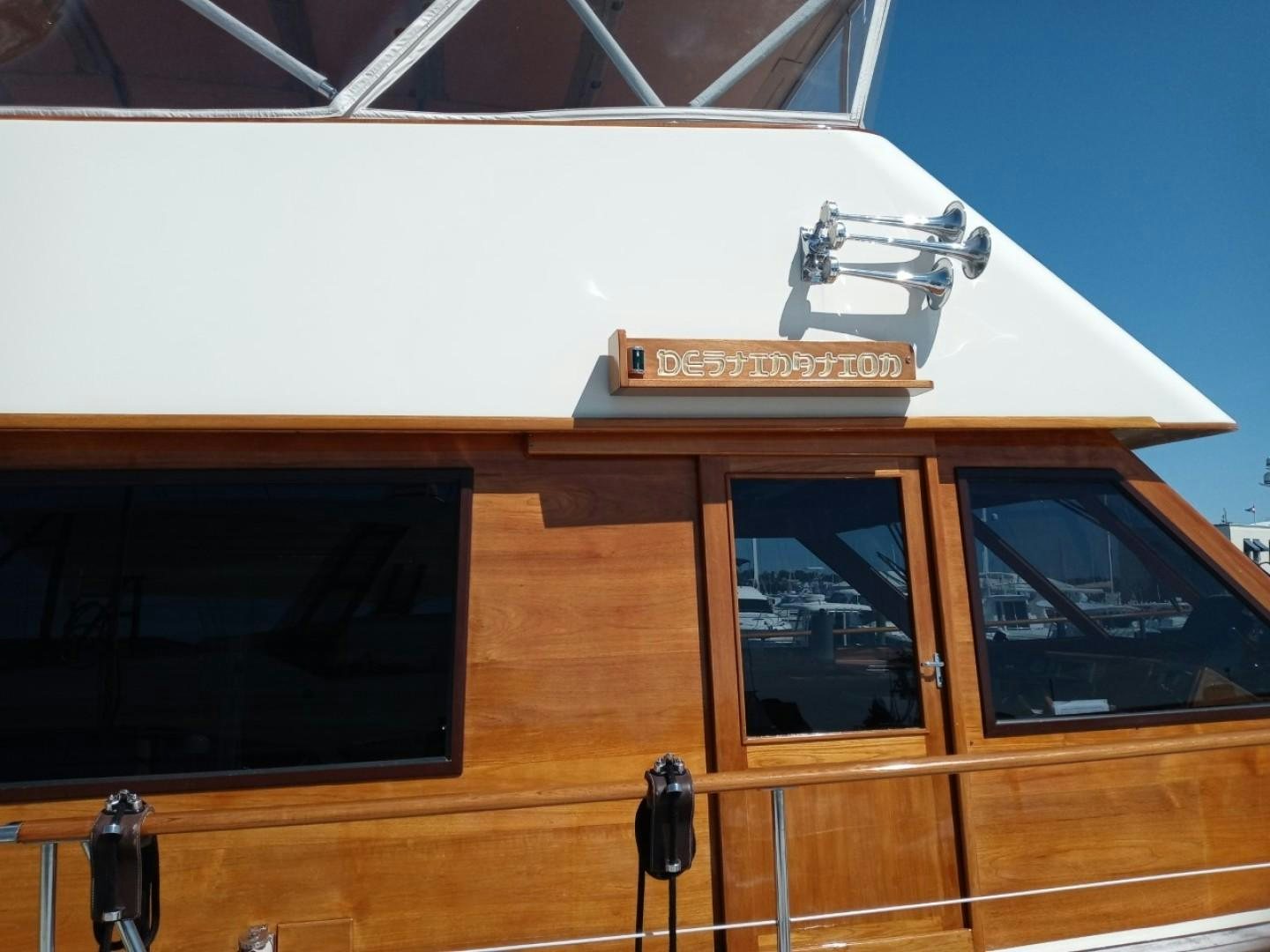 a wooden building with a sign on the roof aboard DESTINATION Yacht for Sale