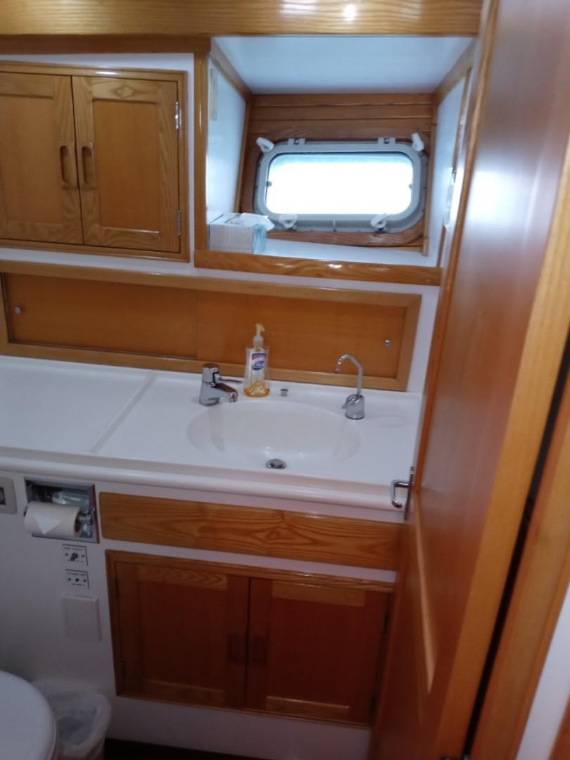 a bathroom with a sink and a mirror aboard DESTINATION Yacht for Sale