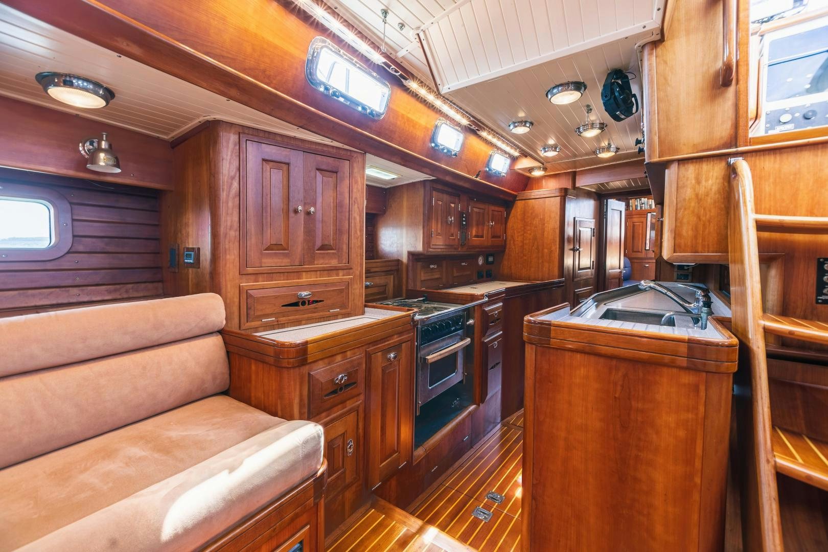 a kitchen with wooden cabinets aboard SHOWTIME Yacht for Sale