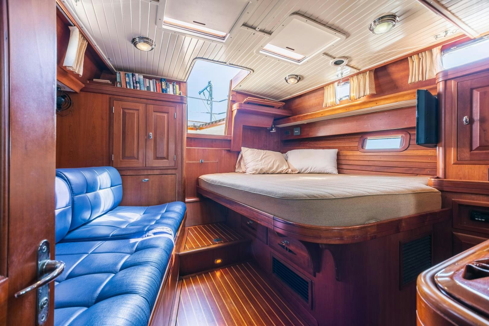 a cabin with a bed and a couch aboard SHOWTIME Yacht for Sale
