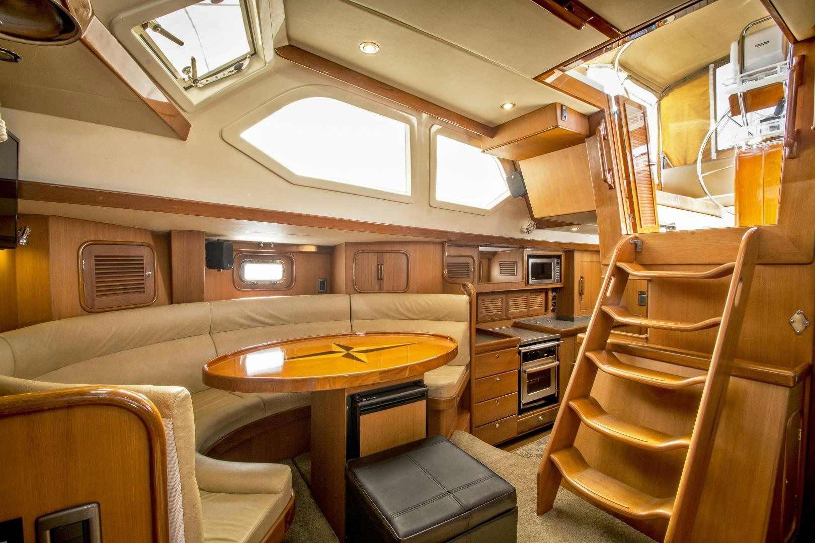 a cabin with a table and chairs aboard REVERENCE Yacht for Sale
