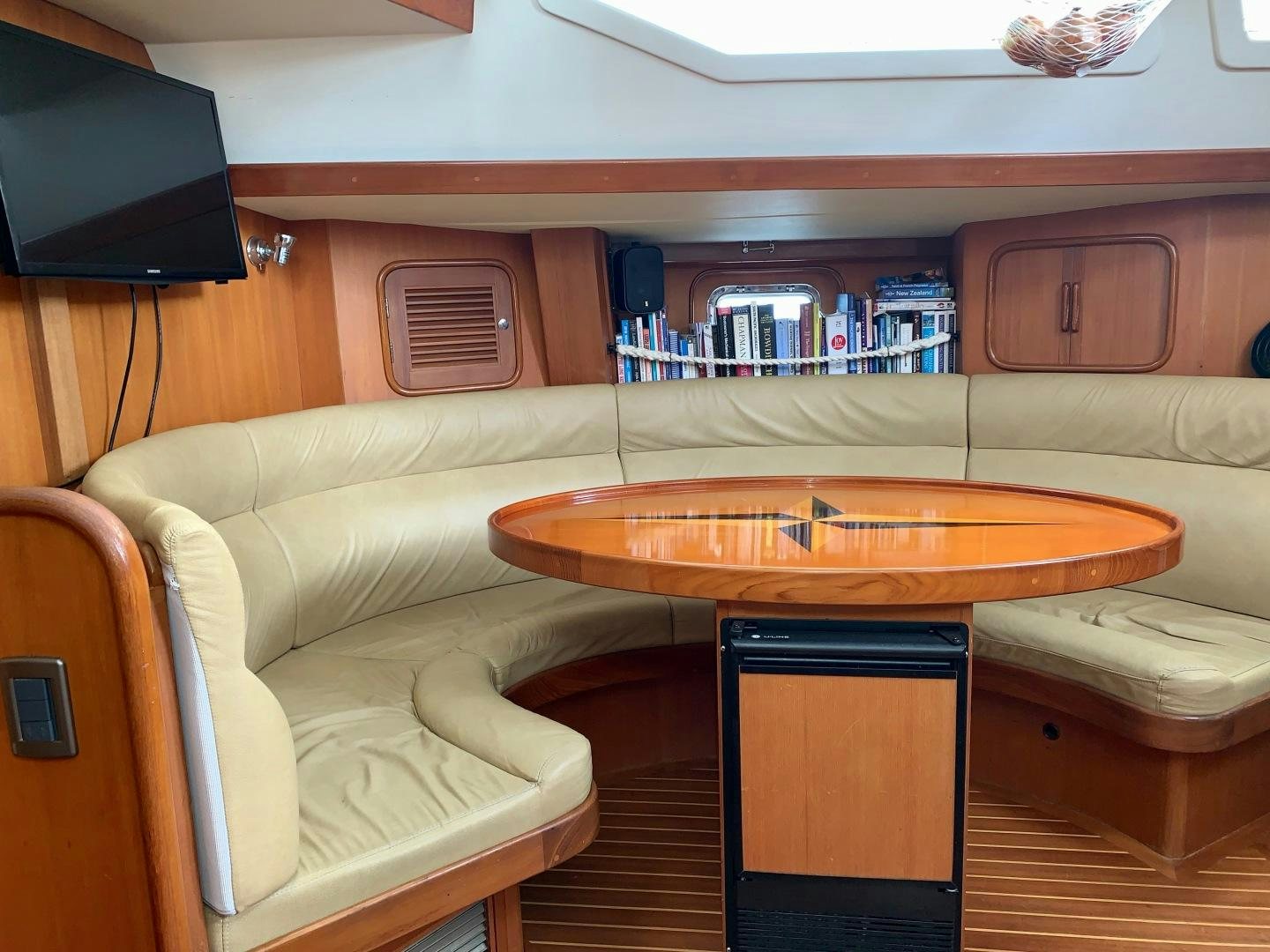 a room with a table and a couch aboard REVERENCE Yacht for Sale