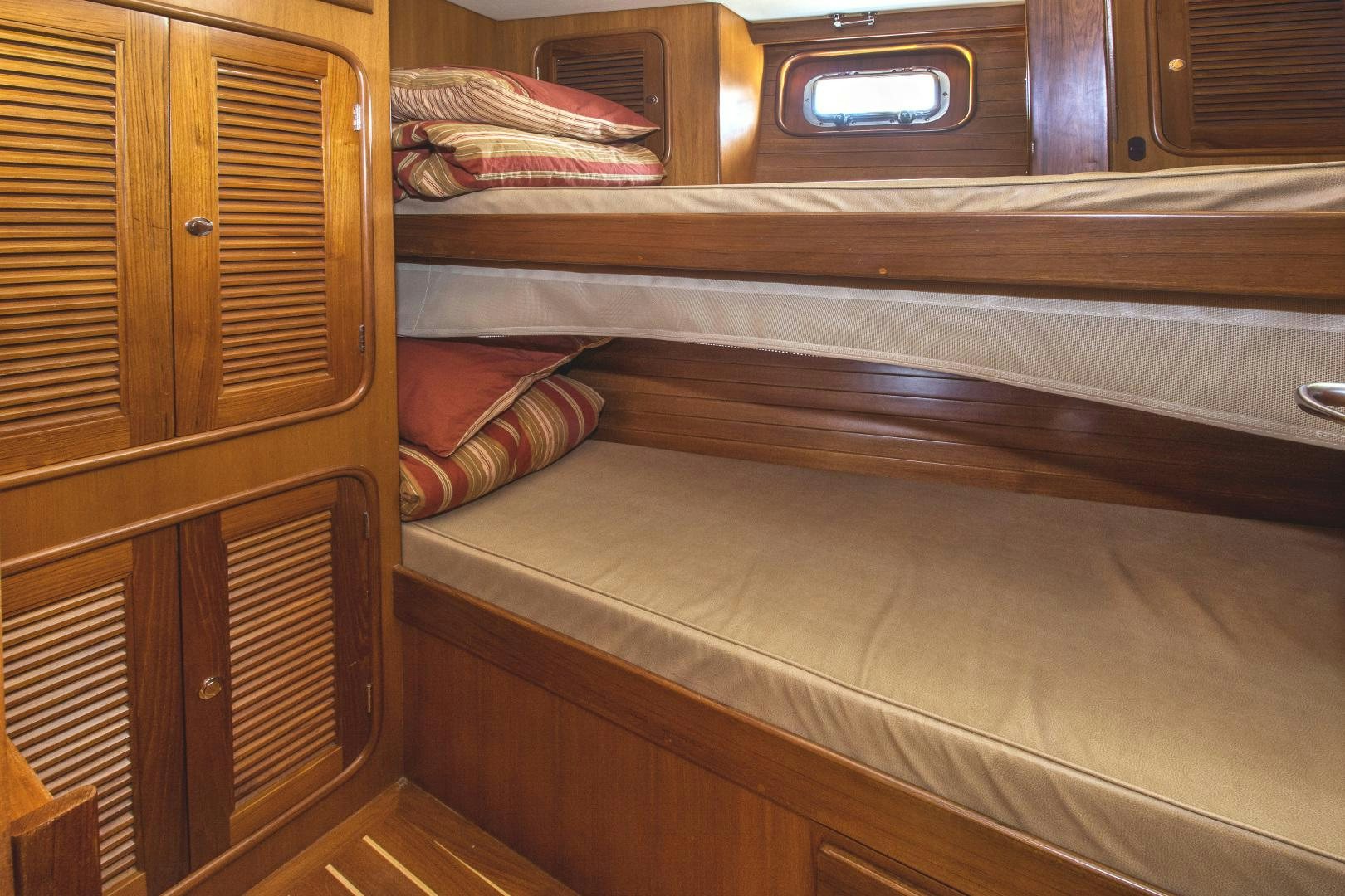 a wooden bunk bed aboard REVERENCE Yacht for Sale