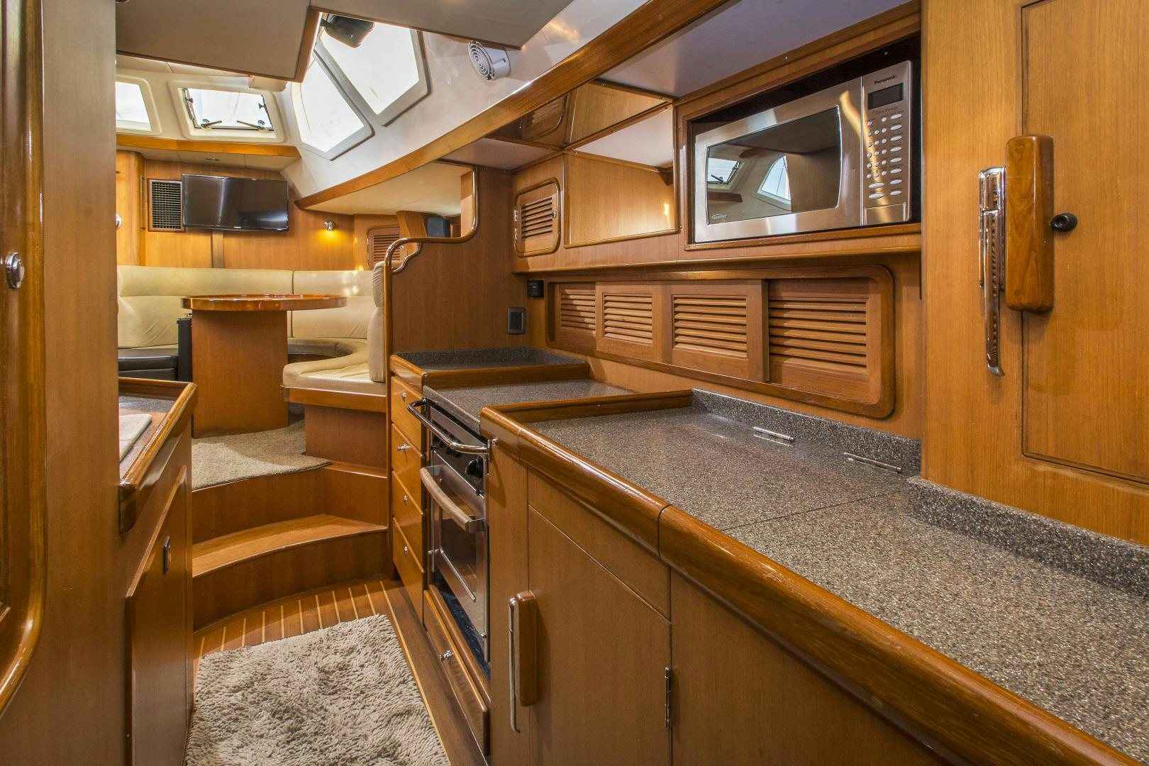 a kitchen with wooden cabinets aboard REVERENCE Yacht for Sale