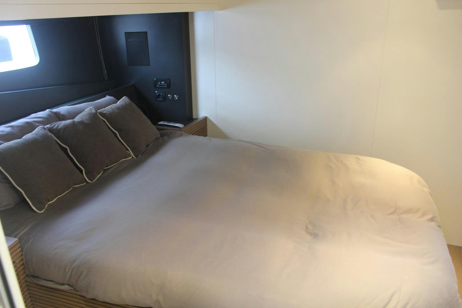 a bed with a pillow and pillows aboard FELINA Yacht for Sale