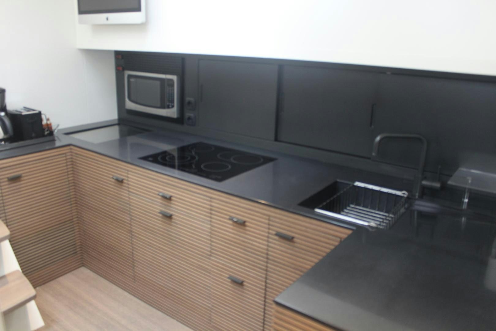 a kitchen with a stove and microwave aboard FELINA Yacht for Sale