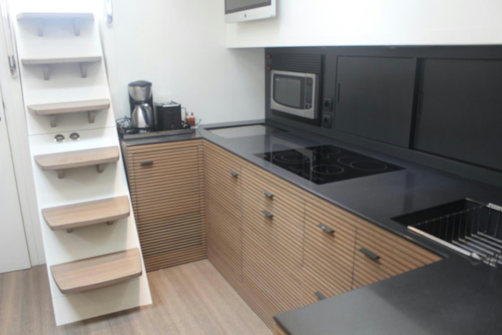 a kitchen with a white shelf aboard FELINA Yacht for Sale