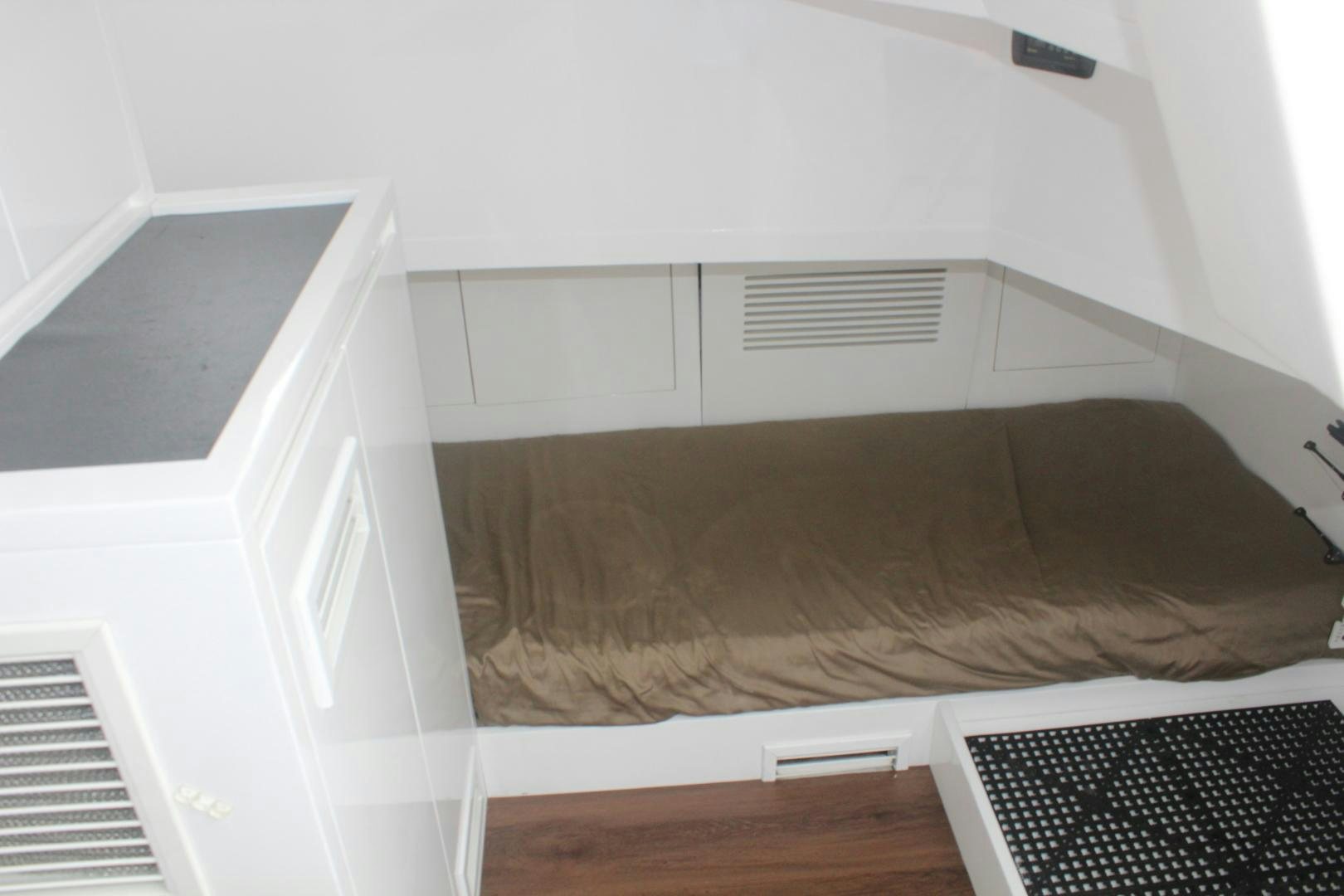 a bed with a white comforter aboard FELINA Yacht for Sale