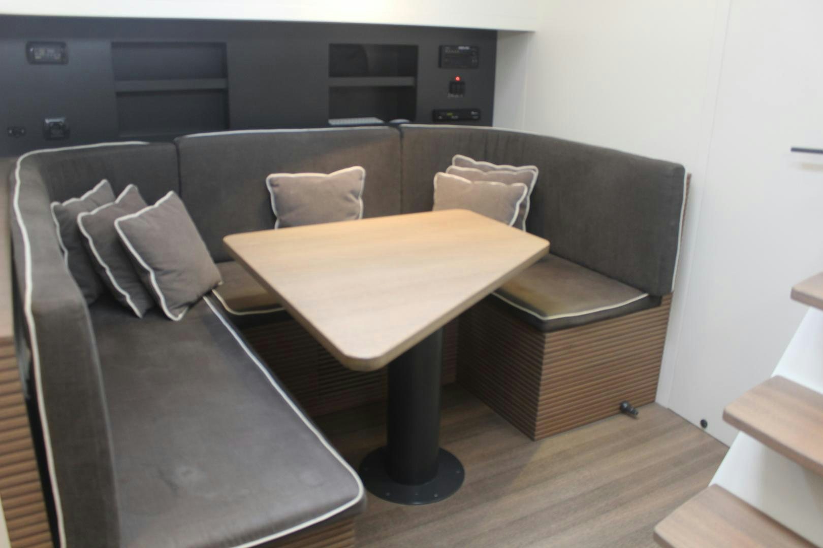 a living room with a couch and a table aboard FELINA Yacht for Sale