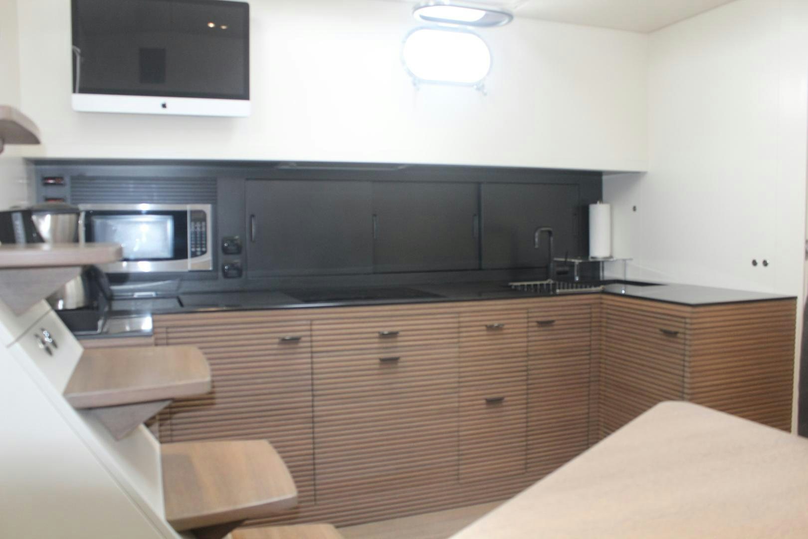 a kitchen with wooden cabinets aboard FELINA Yacht for Sale