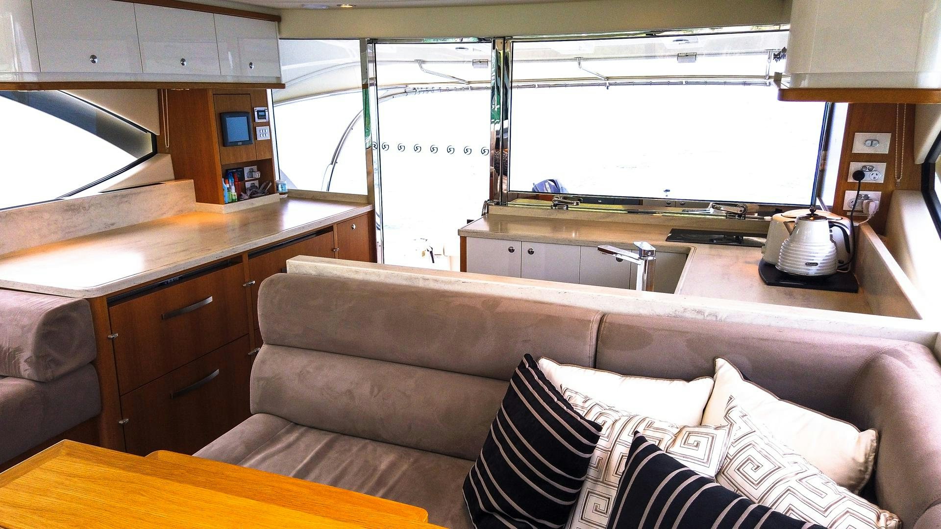 a couch with pillows in a room aboard SURVIVOR Yacht for Sale