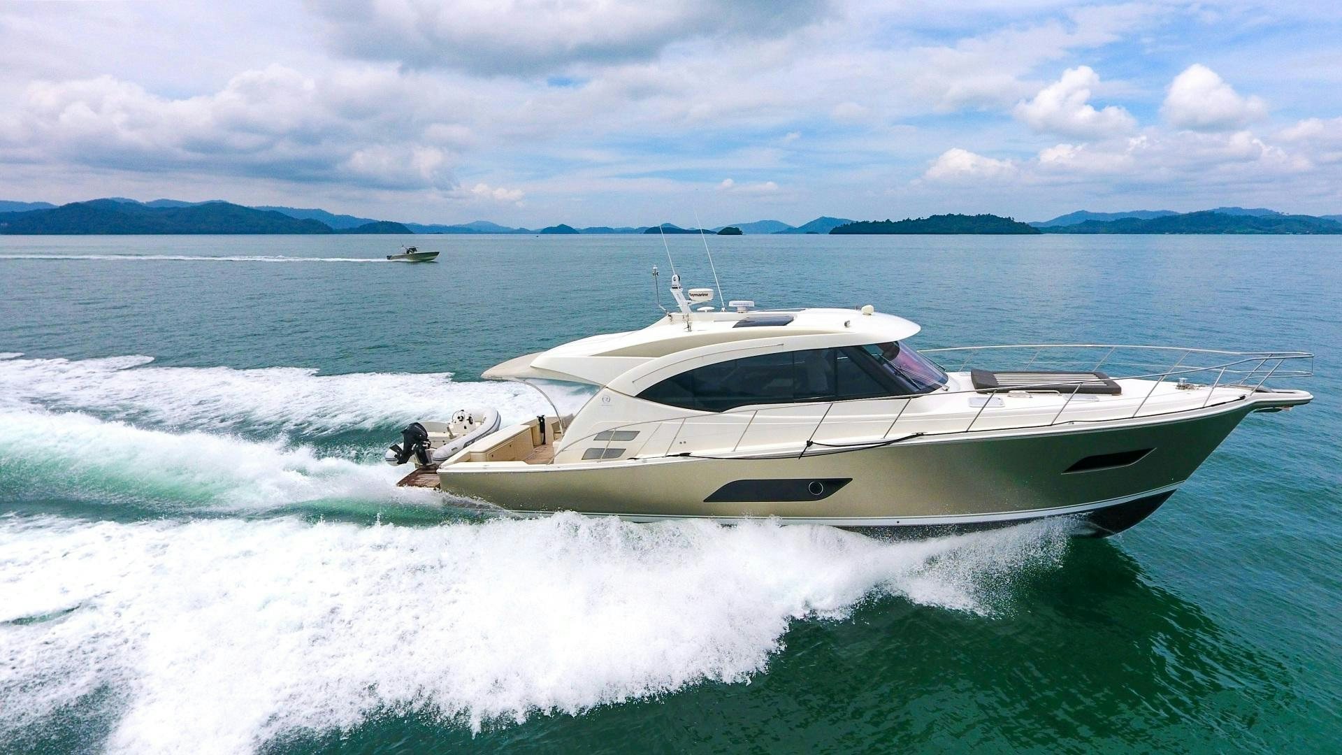 a white boat on the water aboard SURVIVOR Yacht for Sale