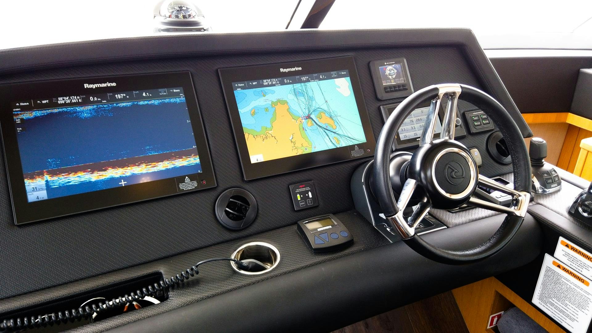 a computer with a screen and a game controller aboard SURVIVOR Yacht for Sale