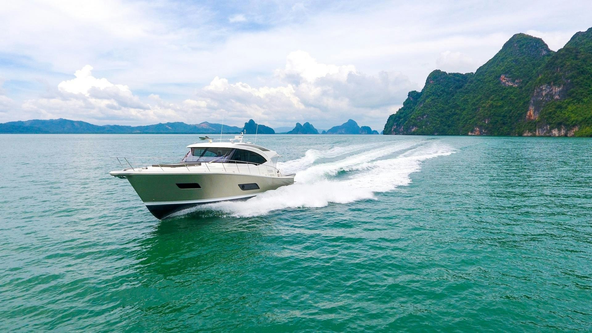 a white boat on water aboard SURVIVOR Yacht for Sale