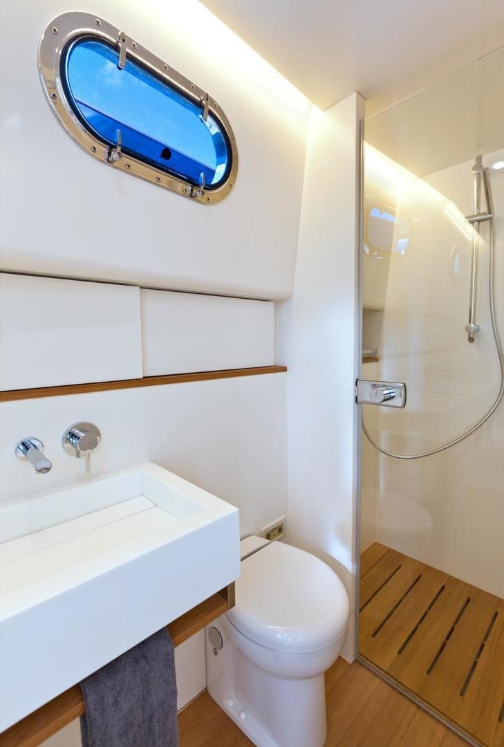 a bathroom with a sink and a toilet aboard LANGARA Yacht for Sale