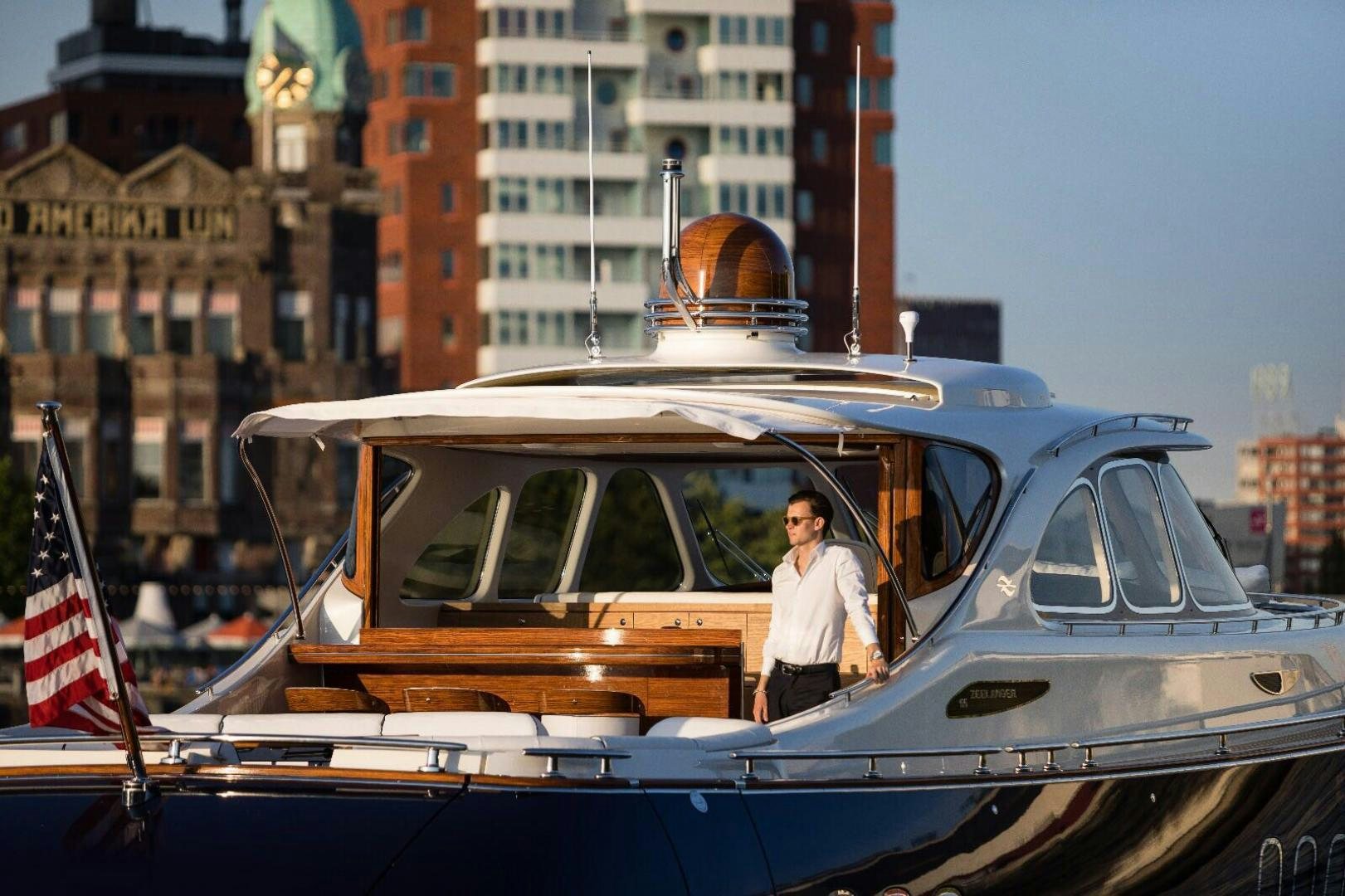 a person standing next to a boat aboard ALMOST HEAVEN Yacht for Sale