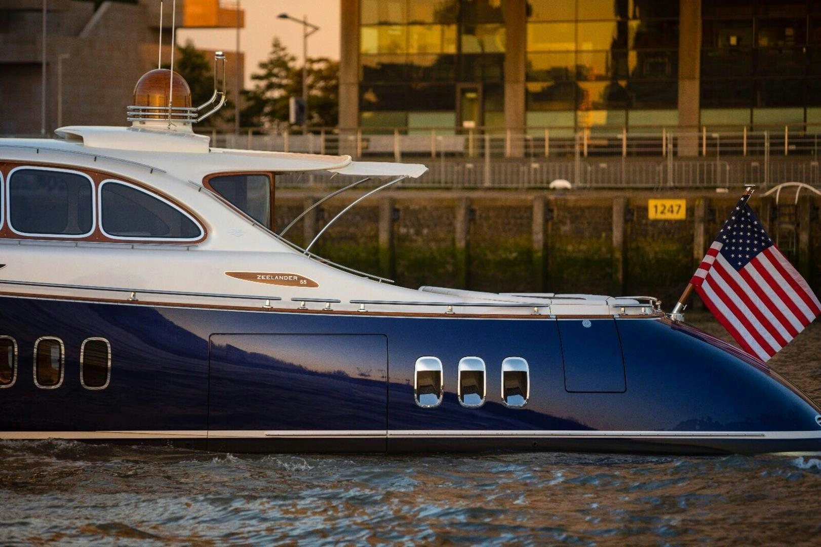 a boat with a flag on the front aboard ALMOST HEAVEN Yacht for Sale