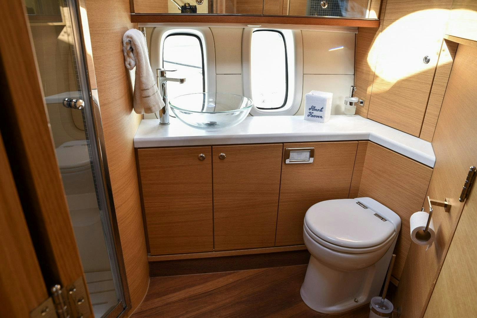 a bathroom with a toilet and a sink aboard ALMOST HEAVEN Yacht for Sale
