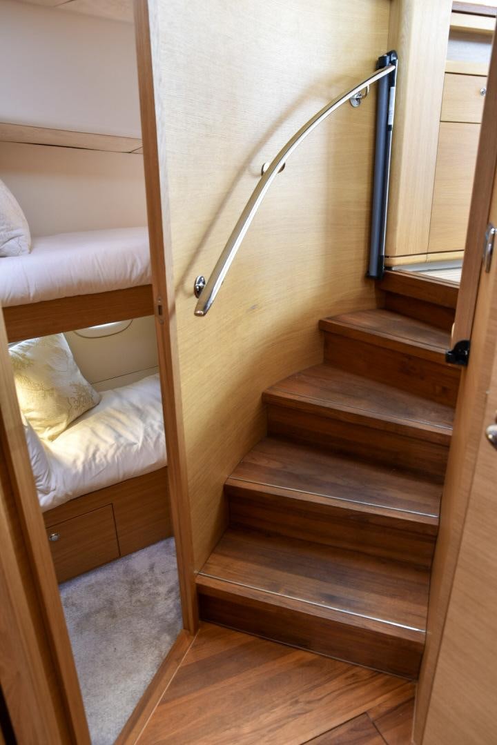 a wooden staircase with a light fixture aboard ALMOST HEAVEN Yacht for Sale