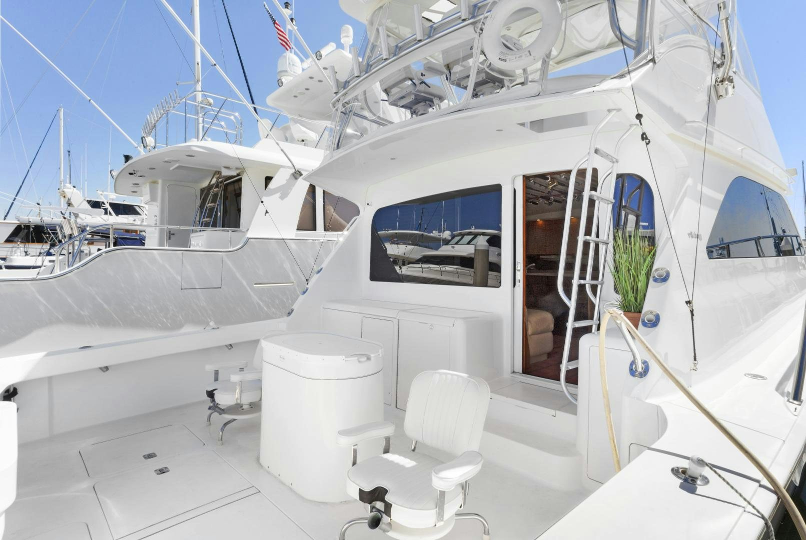 a white boat with a chair and a chair on the deck aboard ROCKETSHIP Yacht for Sale