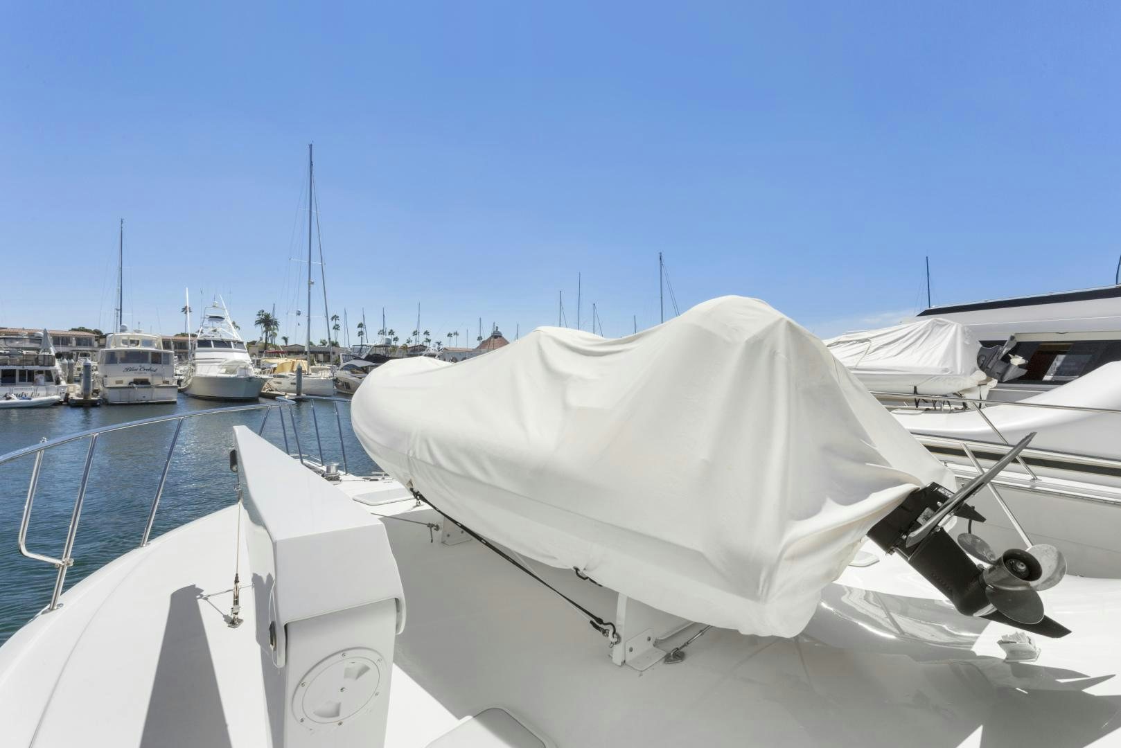 a white boat in a harbor aboard ROCKETSHIP Yacht for Sale