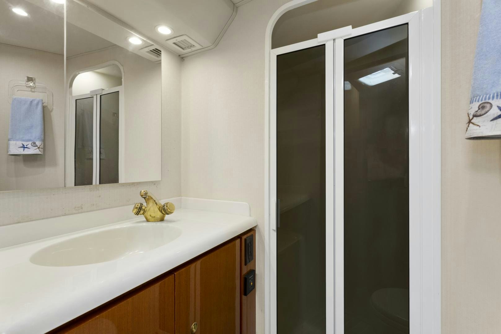 a bathroom with a sink and a mirror aboard ROCKETSHIP Yacht for Sale