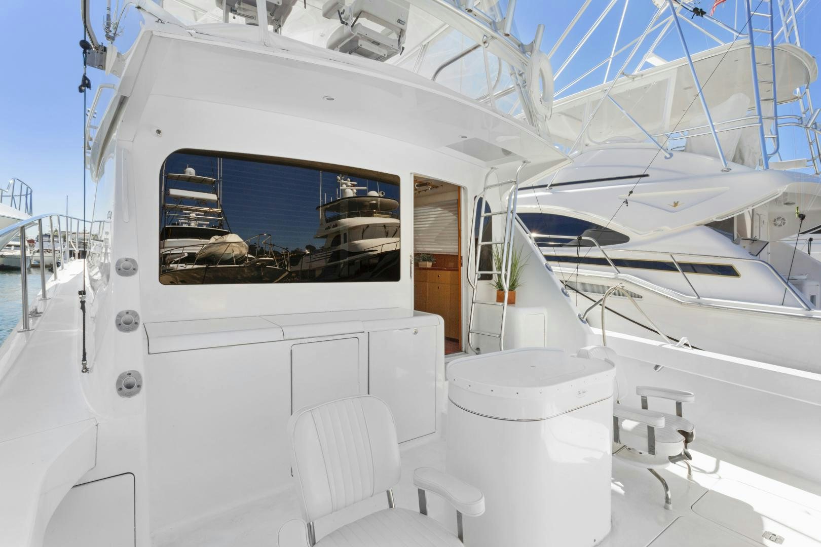 a white boat with a window aboard ROCKETSHIP Yacht for Sale