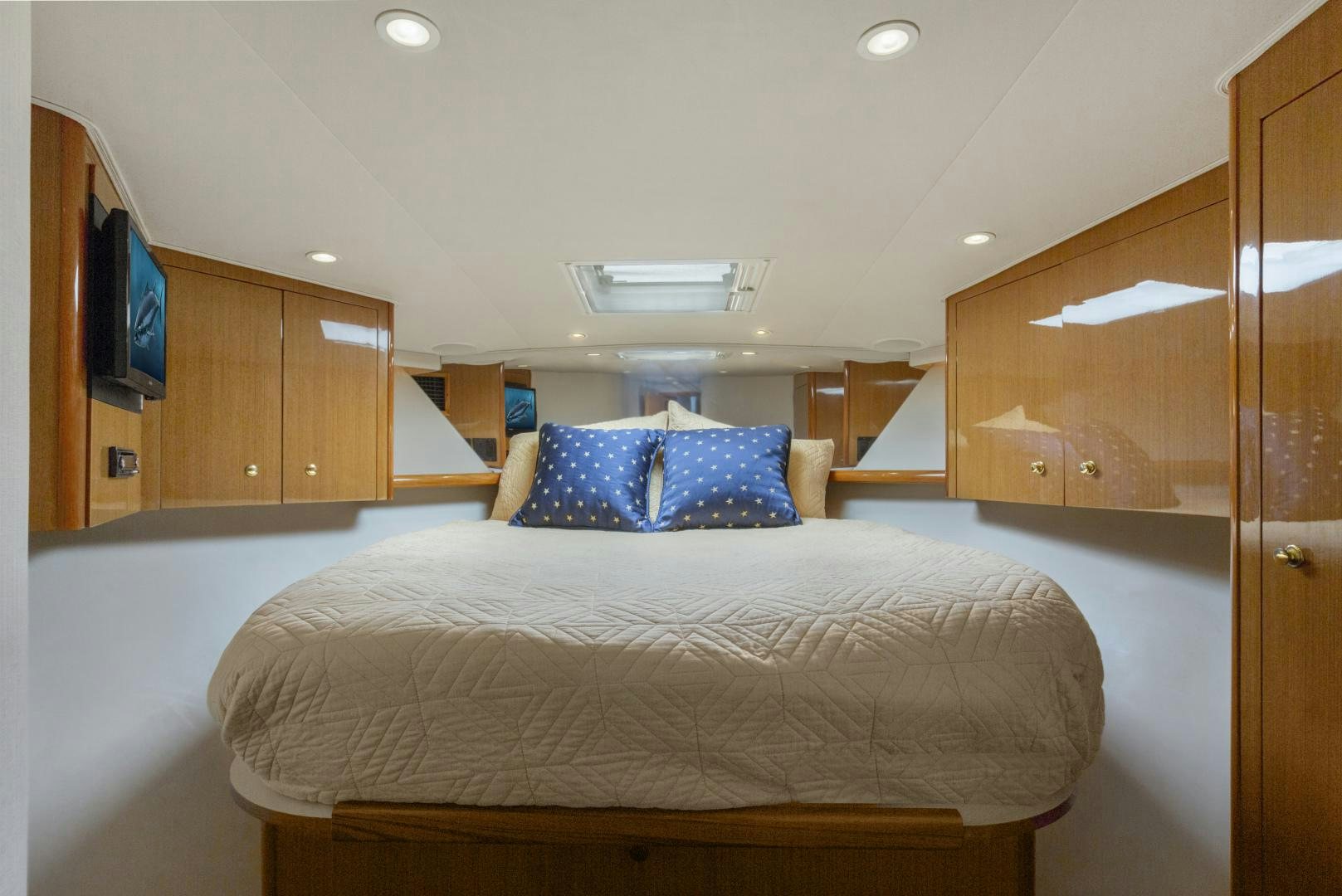 a bedroom with a bed and cabinets aboard ROCKETSHIP Yacht for Sale